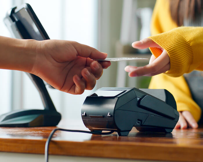 Customer tapping a credit card at a payment terminal