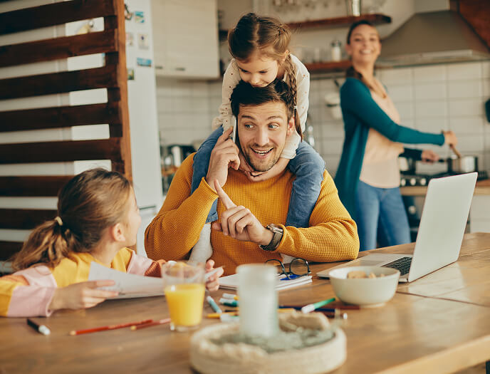 Family using devices together at the kitchen table