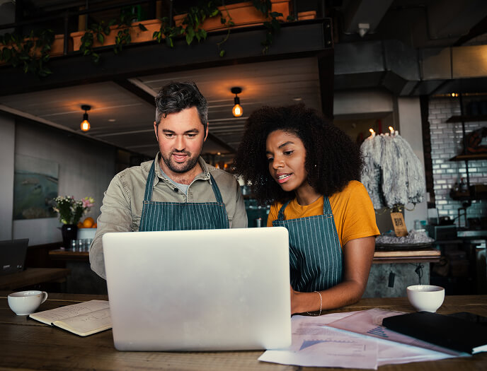 Small business team looking at a laptop
